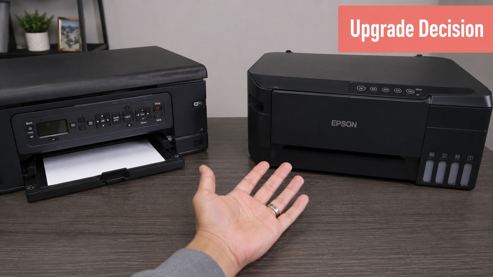 A person gesturing towards an Epson EcoTank printer compared to an older printer model on a desk.
